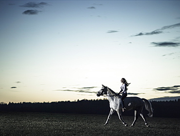 girl riding her horse at dusk, Freising, Bavaria, Germany