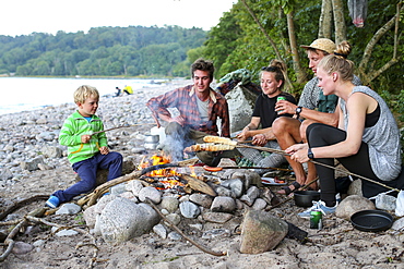 Stickbread and sausages over a campfire, barbecue, Baltic sea, Bornholm, near Gudhjem, Denmark, Europe