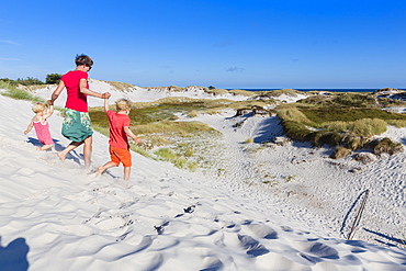 Young family, walking through the dunes of Dueodde, sandy beach, Summer, Baltic sea, Bornholm, Dueodde, Denmark, Europe, MR