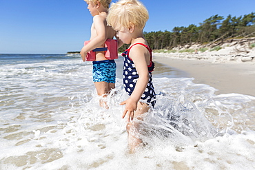 Young sister and her brother playing in the waves, dream beach between Strandmarken und Dueodde, sandy beach, baltic sea, MR, Bornholm, Strandmarken, Denmark, Europe