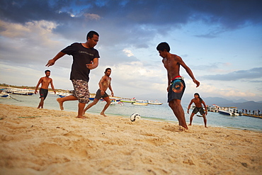 Young locals playing football on Trawangan beach, Gili Trawangan, Lombok, Indonesia