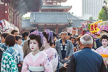 Three Geisha and man in yukata with stroller during Sanja Matsuri, Asakusa, Tokyo, Japan