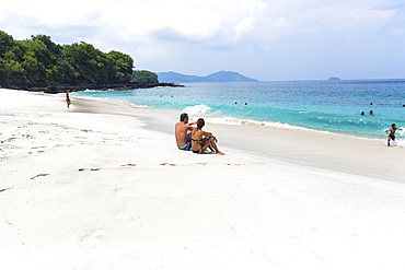 Vacationers at the white sand beach, Padangbai, Bali, Indonesia