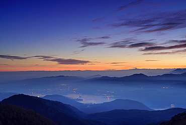 View to lake Lago d'Orta and Cottian Alps in the background, view from Mottarone, Piedmont, Italy