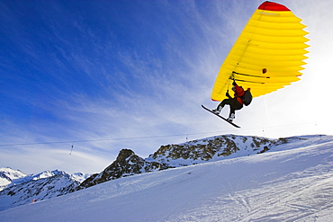 A man with snowboard using a Woopy-Jump, Grimentz, Valais, Switzerland