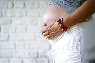 Pregnant woman holding belly, Styria, Austria