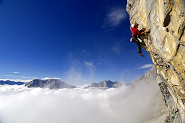 Climber at Schuesselkar rock face in the sunlight, Tyrol, Austria, Europe