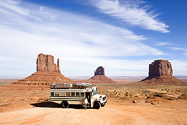 View towards an American Schoolbus with a woman at the entrance door, Monument Valley, Arizona, USA