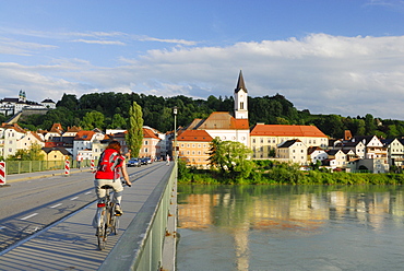 Female cyclist passing bridge over river Inn, Danube Cycle Route Passau Vienna, Passau, Lower Bavaria, Bavaria, Germany