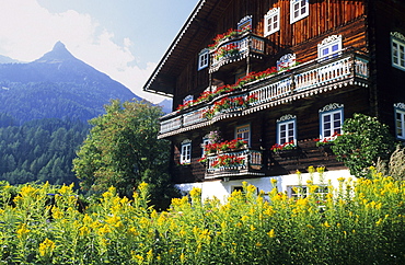 Traditional farmhouse with flower decorations, Kals, Glockner range, Hohe Tauern, East Tyrol, Tyrol, Austria