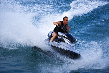 Man driving a water scooter, Jetski, Lake Garda, Italy