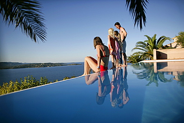 Family on poolside, Bay of Porto Vecchio, Southern Corse, France