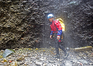 Man walking throuhg gorge, swim and hike canyon Raebloch, Emmental valley, Canton of Bern, Switzerland, MR