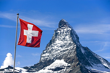 Swiss flag in front of the Matterhorn 4478 meters, Zermatt, Valais, Switzerland