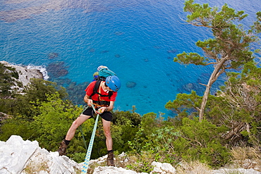 Man abseiling, Il Sentiereo Selvaggio Blu, Golfo di Orosei, Sardinia, Italy, MR