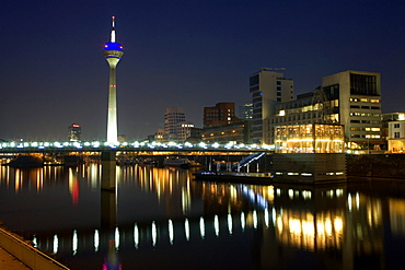 Modern architecture of the Media Harbour at night with television tower, Neuer Zollhof, Düsseldorf, state capital of NRW, North-Rhine-Westphalia, Germany