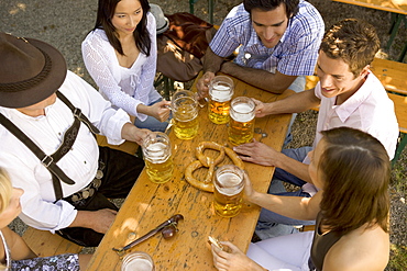 Medium group of people sitting at table in beer garden, Munich, Bavaria