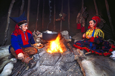 Lapps wearing traditional costumes at a bonfire, Mageroeya, Finnmark, Norway, Europe