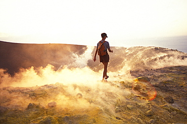 Person walking through sulphur vapour, Caldera, Gran Cratere, Vulcano, Aeolian Islands, Italy