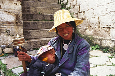 Tibetan woman with prayer wheel, Lhasa, Tibet, Asia