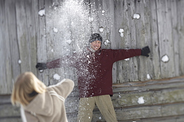 Family throwing snowballs