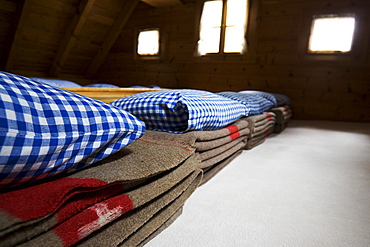 Woolen blankets in a dormatory. Cluozza hut, Cluozza Valley, Val Cluozza, Swiss Nationalpark, Engadin, Graubuenden, Grisons, Switzerland, Alps