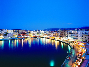 Illuminated Venetian Harbour at night with restaurants, Chania, Crete, Greece