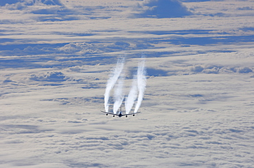 Airplane flying over sea of clouds