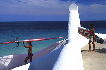 Men carrying surfboards to the sea, Sotavento de Jandia, Fuerteventura, Spain, Europe