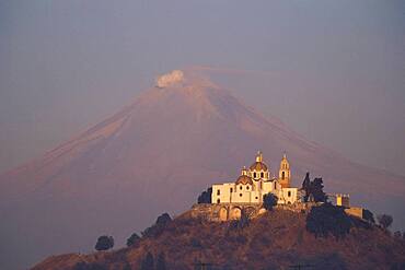 Church of Cholula and Popocatepetl volcano in the evening sun, Mexico, America