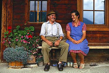 Local married couple before their farmhouse, Bavaria, Germany