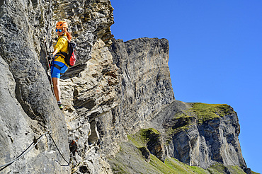 Woman climbs on the Gemmi adventure via ferrata, Gemmi, Bernese Alps, Valais, Switzerland