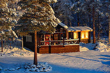 Small holiday home in the winter sun in the forest, Slagnäs, Lapland, Sweden