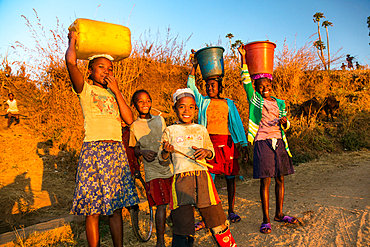 Children come from fetching water, at Ampefy, Merina tribe, highlands, Madagascar, Africa