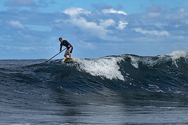 SUP stand up paddler on a breaking wave in the teahupoo surf area, Tahiti Iti, Tahiti, Windward Islands, French Polynesia, South Pacific