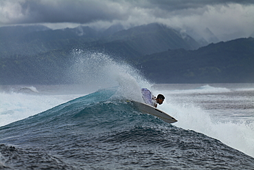 Surfer on breaking wave in Teahupoo surfing area, Tahiti Iti, Tahiti, Windward Islands, French Polynesia, South Pacific