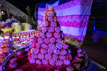 Cake for dessert at the Polynesian evening with a rich buffet and cultural entertainment on board the passenger cargo ship Aranui 5 (Aranui Cruises), at sea near the Marquesas Islands, French Polynesia, South Pacific