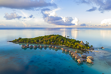 Aerial view of Sofitel Bora Bora Private Island Resort with overwater bungalows in Bora Bora lagoon at sunrise, Vaitape, Bora Bora, Leeward Islands, French Polynesia, South Pacific