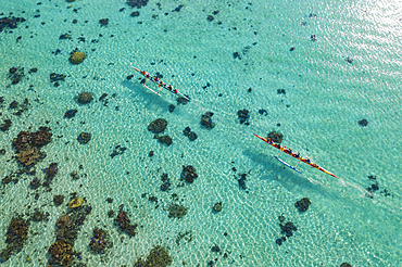 Aerial view of two outrigger racing canoes in the Moorea Lagoon, Avamotu, Moorea, Windward Islands, French Polynesia, South Pacific