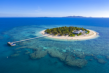 Aerial view of people on SUP stand up paddle boards at Malamala Island Beach Club, Mala Mala Island, Mamanuca Group, Fiji Islands, South Pacific