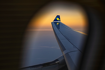 View out of window of a RwandAir Airbus A330-300 airplane with sun logo on winglet at sunrise, on the flight from Brussels International Airport (BRU) in Belgium to Kigali International Airport (KIG) Rwanda, Africa