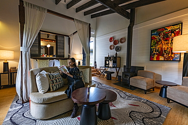 Young woman relaxes in a suite at the luxury resort One