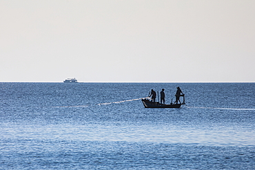 Silhouette of fishermen on boat, Ong Lang, Phu Quoc Island, Kien Giang, Vietnam, Asia