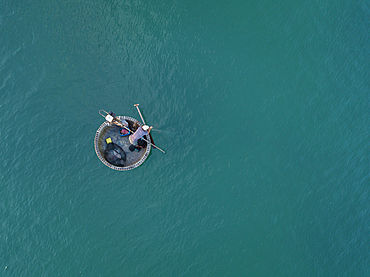 Aerial view of fisherman in traditional round boat in turquoise water, Ong Lang, Phu Quoc Island, Kien Giang, Vietnam, Asia