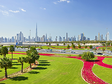 Skyline, green WIese, palm trees, flowers, Dubai, United Arab Emirates