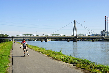 Woman inline skating near river Danube, Linz, Upper Austria, Austria