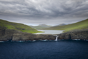 Coast, waterfall and cliffs at Trælanípa on the island of Vagar, on Lake Leitisvatn, Faroe Islands