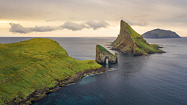 Rock formations of Drangarnier and Tindholmur Island and Mykines in sunset on Vagar, Faroe Islands