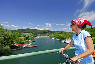 Female cyclist on bridge over river Erlauf, Danube Cycle Route Passau Vienna, Poechlarn, Wachau, Lower Austria, Austria