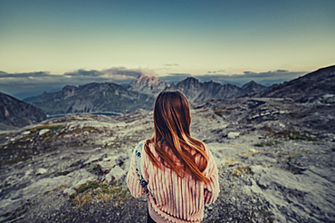 Woman sitting in the mountains in the Rätikon above the Lünersee, Vorarlberg, Austria, Europe